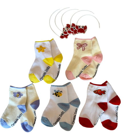 Set of colorful baby socks with various designs on a textured surface